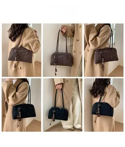 Detail view of vintage matte shoulder bag with unique wooden bead tassel in brown and black