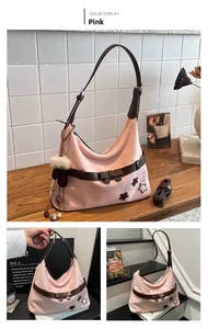Detailed views of pink suede shoulder bag with star patches and adjustable strap