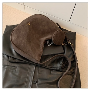 Detail of dark brown matte hobo bag featuring gold hardware and a small coin purse