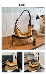 Detail of khaki suede hobo bag featuring brown leather trim and star patch accent