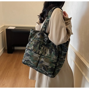 Detail of durable camouflage canvas tote bag with two large front utility pockets