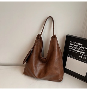 Detail of dark brown tote bag in vintage crinkled leather with matching coin purse