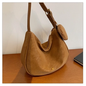 Detail of vintage brown suede hobo bag with gold hardware and matching round coin purse
