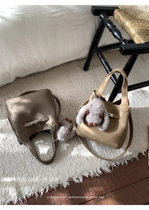 Detail of mini leather bucket bags with silver hardware and plush rabbit charms