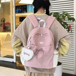 Damen-Rucksack aus Segeltuch in Pink und Beige mit Schleife und herzförmigem Anhänger