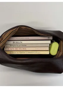 Interior view showing the large capacity and striped lining of the dark brown leather bag