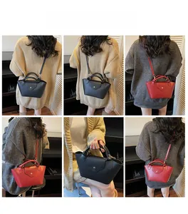 Detailed views of black and red crossbody bucket bags with textured finish on models
