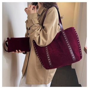 Detail of burgundy suede tote bag set with silver rivets and matching zipper pouch