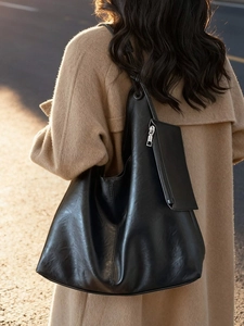 Large black soft leather tote bag with a matching pouch for stylish daily commuting use