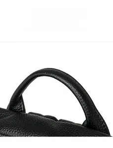 Close-up of woven handle on black lychee grain leather backpack showing stitching