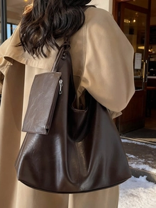 Minimalist deep brown large capacity tote bag with matching pouch on model