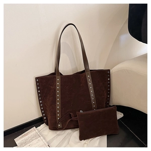 Detail of deep brown suede tote with silver metal rivets and matching zipper pouch