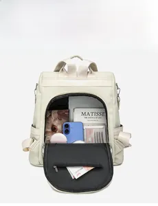 Detailed interior view of a cream woven backpack showing large storage capacity