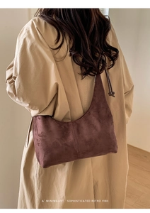 Detail of suede hobo bag with unique knotted drawstring side detail and retro stitching