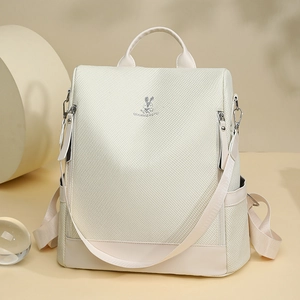 Detail of beige backpack with honeycomb texture and rabbit metal logo detail