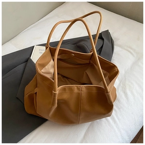 Macro view showing spacious interior and magnetic clasp of brown matte tote bag