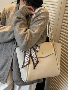 Chic beige lychee leather tote bag with silk scarf on handle, ideal for office commuting