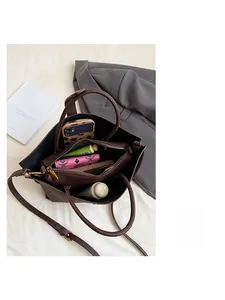 Detail view of deep brown pebbled leather bag interior with zipper pocket and large capacity