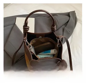 Intérieur spacieux d'un sac seau léopard montrant l'espace pour téléphone et maquillage
