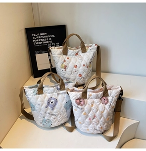 Detailed view of quilted cotton tote bags featuring cute cartoon patterns and strap textures
