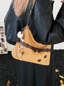 Fashionable camel suede hobo shoulder bag with leather bow and star patchwork detail