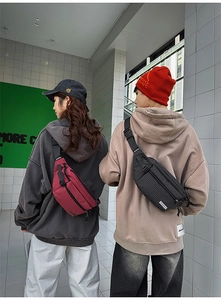 Detail of red and black checkered crossbody chest bags with adjustable straps on a model
