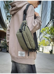 Detail of army green checkered sling bag with adjustable strap and logo patch