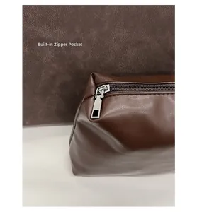 Close-up of the brown leather inner zipper pouch with silver hardware for tote bag