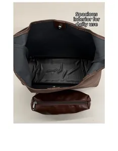 Detail of the brown faux leather tote bag interior with magnetic closure and pouch