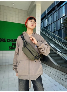 Close-up of olive green checkered crossbody bag with adjustable black strap and buckle