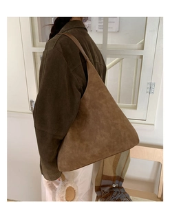 Brown suede tote bag side view on shoulder showing minimalist retro style and large capacity