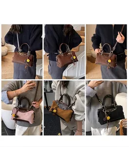 Close-up of suede Boston bags in multiple colors featuring chic bow and pompom details