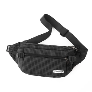 Close-up of black checkered waist bag with dual zippers and adjustable nylon buckle strap