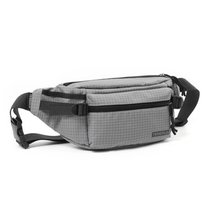 Detail showing the gray grid texture and nylon strap with quick-release buckle on chest bag