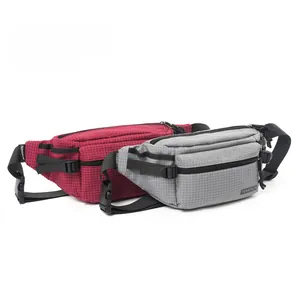 Detail view of plaid outdoor chest bags with zippers, adjustable straps and durable fabric