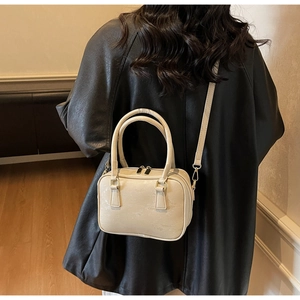 Boston bag in cream suede with water ripple texture and adjustable crossbody strap