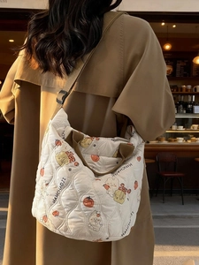 Quilted white puffer tote bag with cartoon bear print and adjustable brown shoulder strap