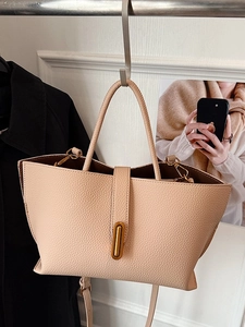 Elegant beige pebbled leather bucket bag with gold vertical clasp for women