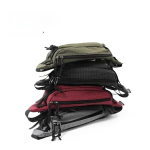 Vertical stack of techwear crossbody bags in army green, black, red, and grey tones