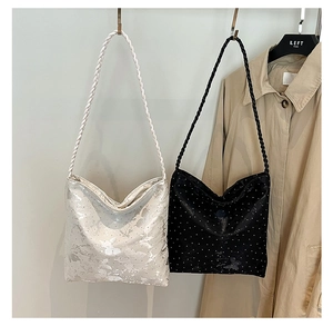 Detail of shoulder bags featuring butterfly jacquard and glitter textures with rope straps