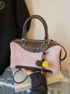 Pink suede and brown leather Boston bag with bow and pompom charm on silver suitcase