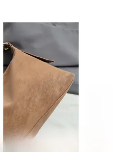 Detail of vintage brown textured leather tote showing fine grain and sturdy stitching