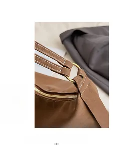 Close-up of premium brown leather texture with golden hardware and white stitching details