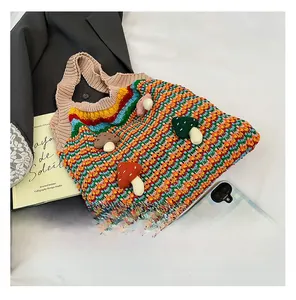 Detail of colorful rainbow crochet tote bag featuring 3D handmade mushroom decorations
