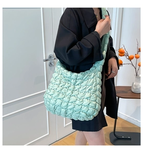 Detalle del bolso nube verde menta mostrando la textura de nailon plisado y la correa