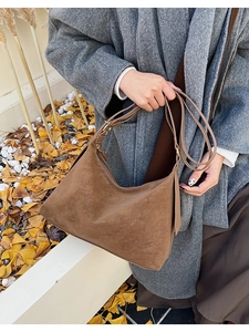Detail of caramel suede hobo bag showing high-quality texture and metal zipper closure