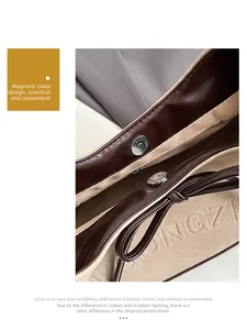 Close-up of magnetic buckle closure and leather bow detail on the shoulder tote bag