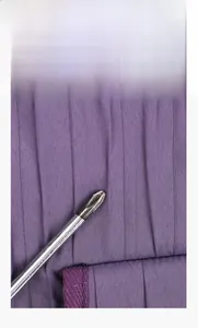 Detail of durable purple Oxford fabric being tested for scratch resistance with a screwdriver