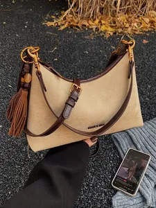 Khaki suede baguette shoulder bag with brown leather trim and retro tassel detail