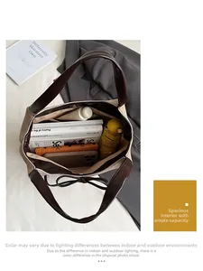 Spacious interior of beige and brown tote bag showing books, phone, and daily essentials